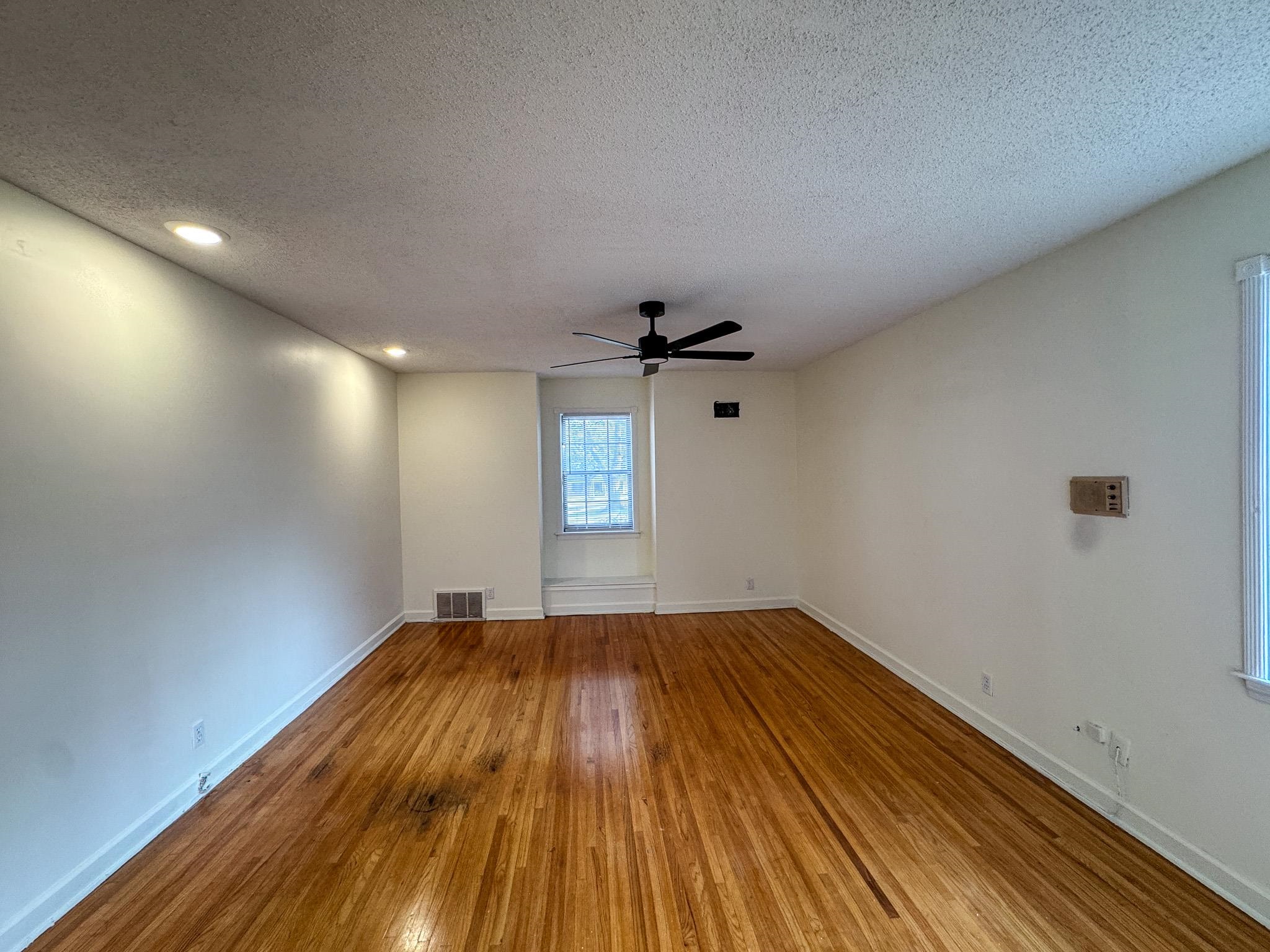 1345 Hickory Ridge Cove Memphis, TN 38116 - Photo 19 of 29 a view of empty room with wooden floor and fan