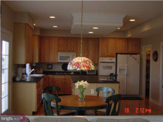 5 Hansel Road Newtown, PA 18940 - Photo 2 of 6 a kitchen with kitchen island granite countertop a stove and a refrigerator