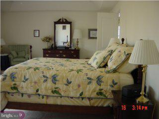 5 Hansel Road Newtown, PA 18940 - Photo 5 of 6 a bed sitting in a bedroom next to a lamp