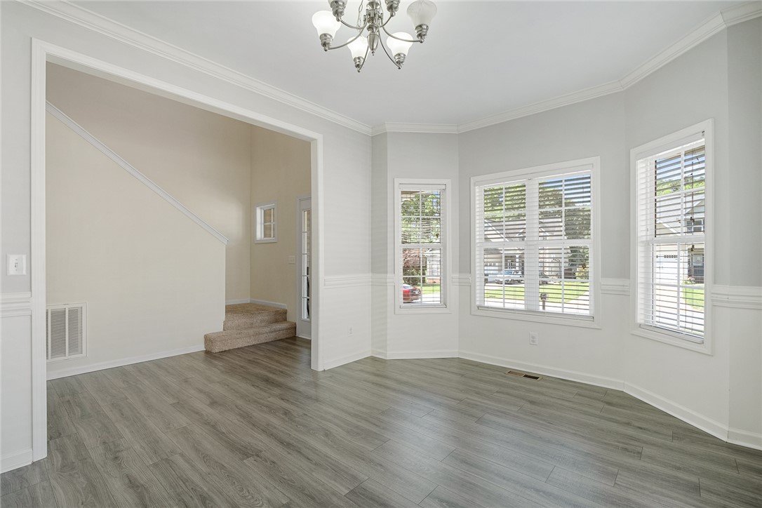 225 Streams Way Anderson, SC 29625 - Photo 11 of 50 This bright room features beautiful flooring and a staircase leading to additional living spaces.