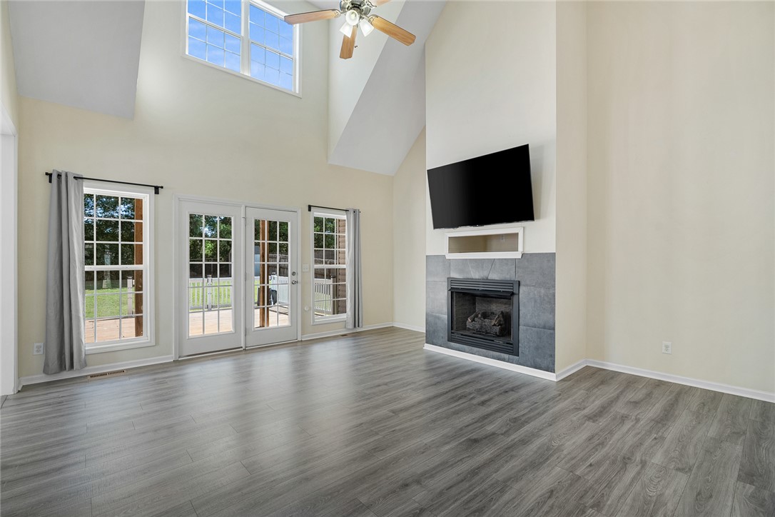 225 Streams Way Anderson, SC 29625 - Photo 12 of 50 This airy living area features high ceilings, a cozy fireplace, and direct access to outdoor living.