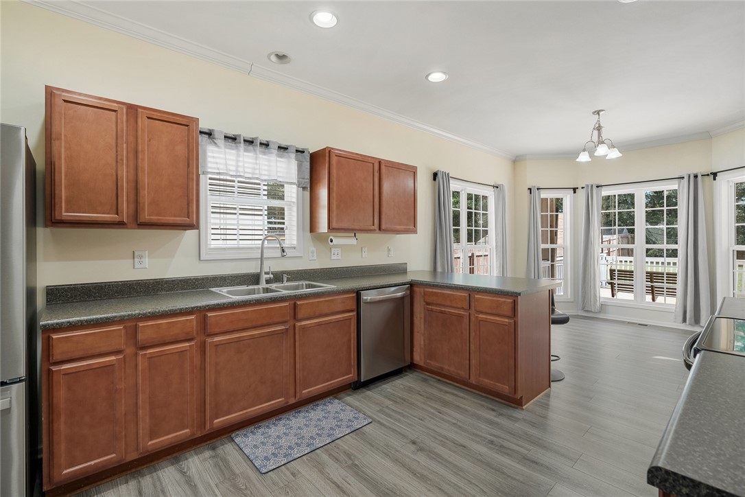 225 Streams Way Anderson, SC 29625 - Photo 18 of 50 This bright kitchen features ample cabinetry, durable LVP flooring, and convenient outdoor access for seamless living - indoor and outdoor!
