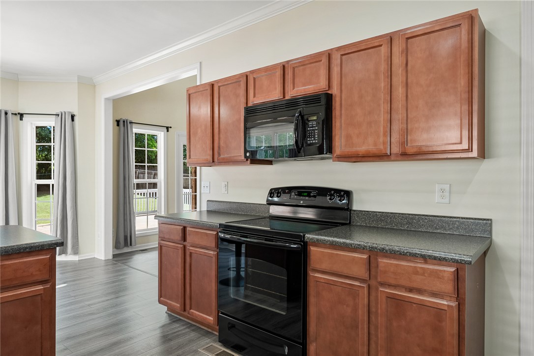 225 Streams Way Anderson, SC 29625 - Photo 19 of 50 This spacious kitchen offers ample cabinet storage and modern appliances for everyday living.