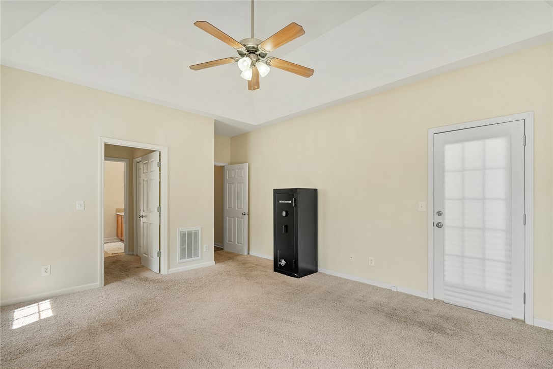 225 Streams Way Anderson, SC 29625 - Photo 25 of 50 The large bedroom features direct outdoor access, creating a comfortable and private retreat.