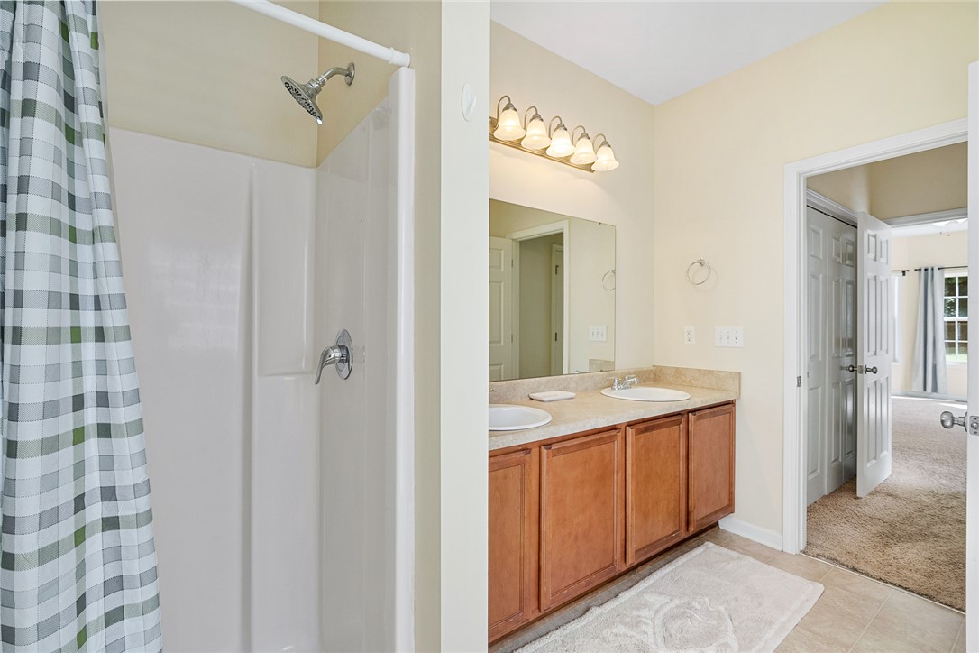 225 Streams Way Anderson, SC 29625 - Photo 30 of 50 This bathroom features a double vanity and a shower area separate from the garden tub.