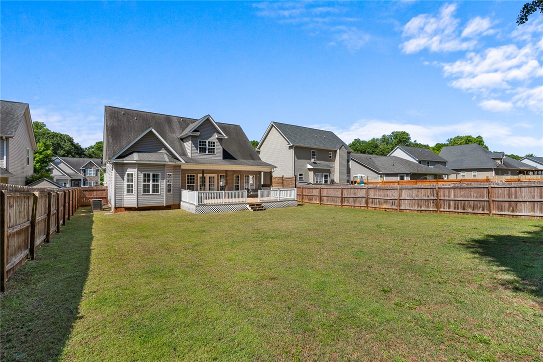 225 Streams Way Anderson, SC 29625 - Photo 49 of 50 This expansive backyard offers lots of room to play and a welcoming deck for outdoor enjoyment.