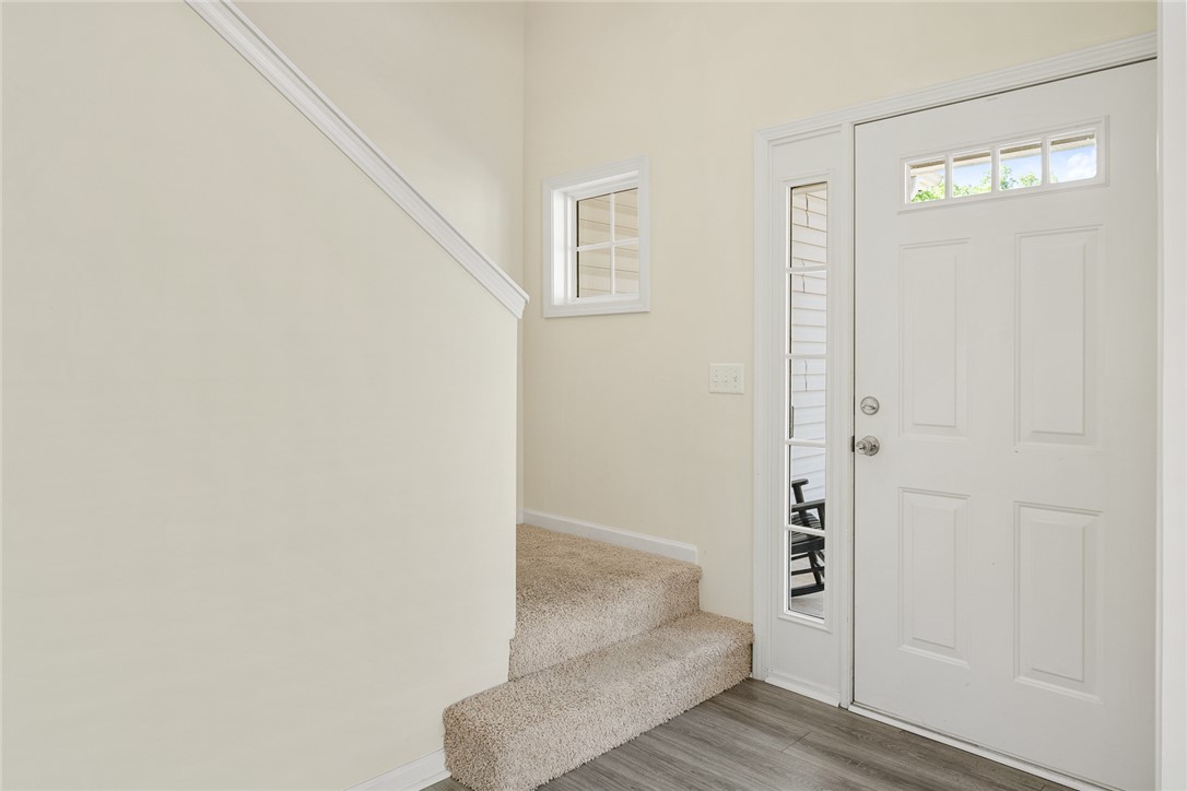 225 Streams Way Anderson, SC 29625 - Photo 7 of 50 The entry welcomes with a clean aesthetic, combining carpeted stairs and durable flooring.