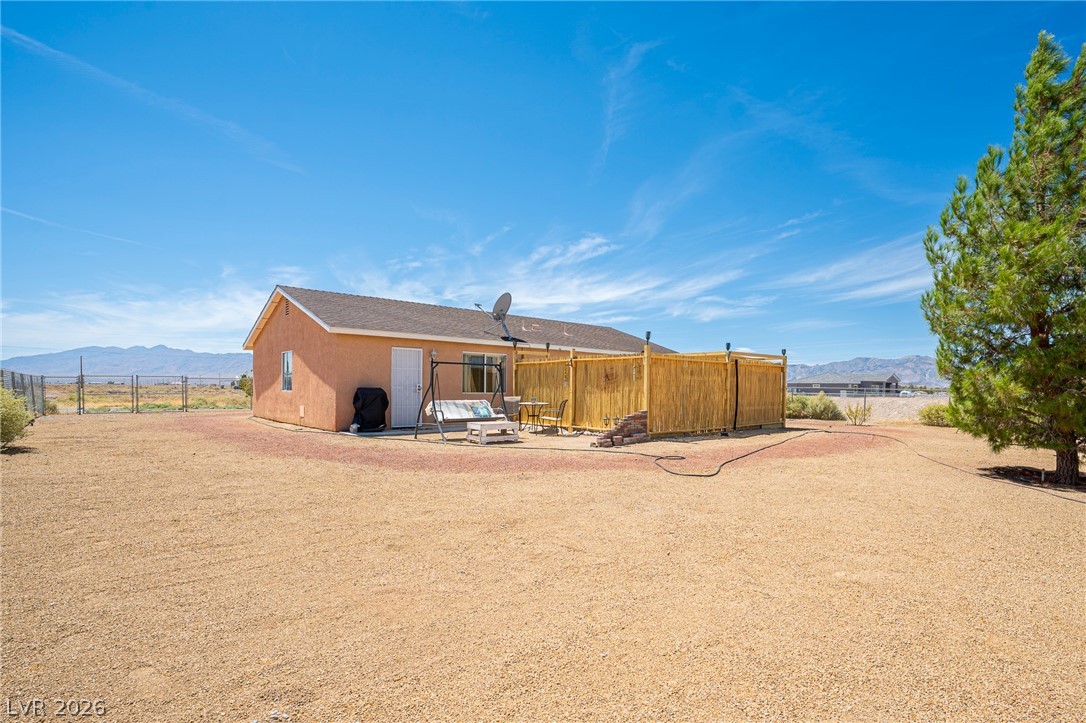 2970 Rio Rico Drive Pahrump, NV 89048 - Photo 32 of 41 An expansive gravel yard surrounds this classic stucco single-story residence under clear desert skies.