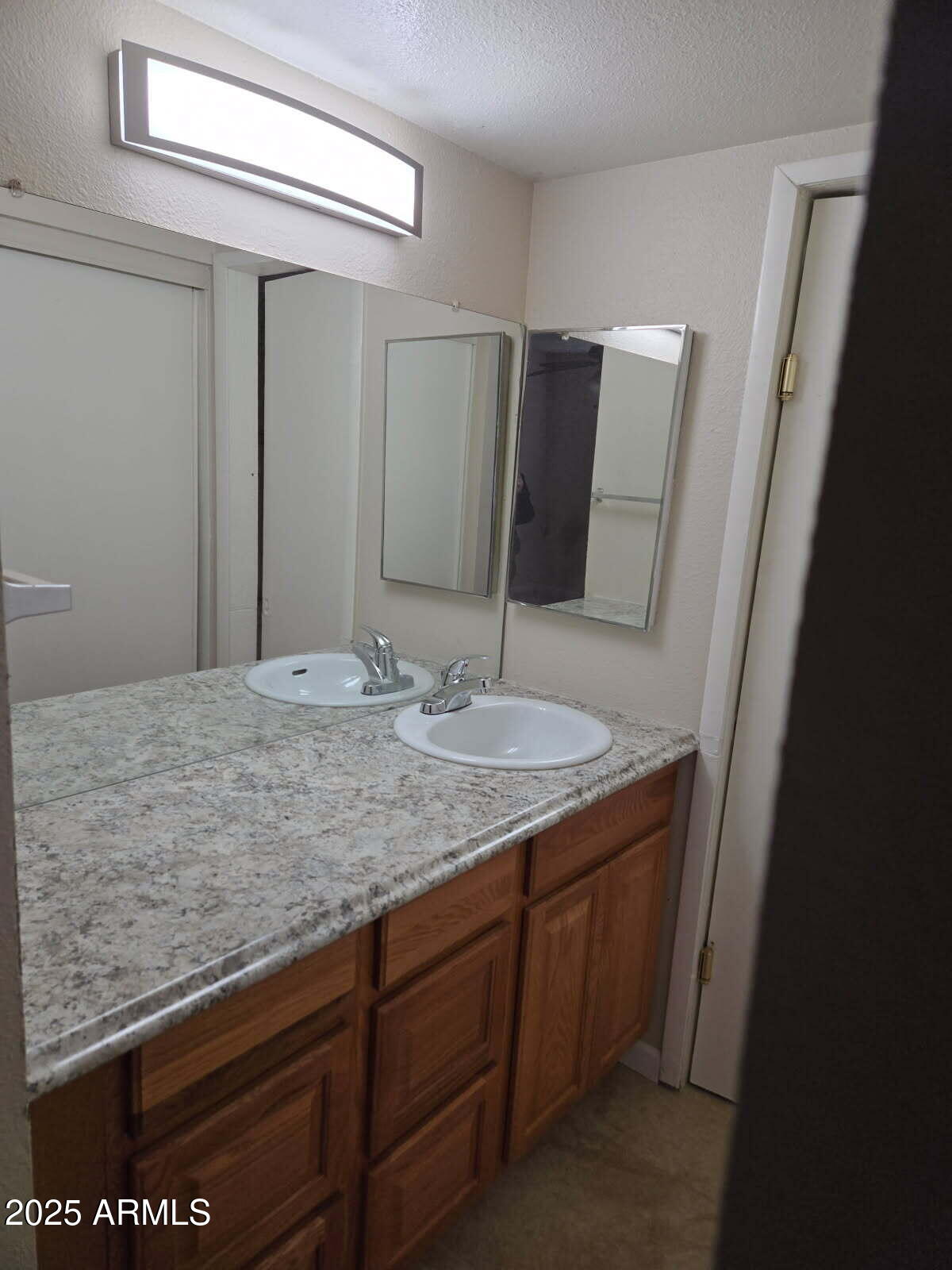 6008 West Acoma Drive Glendale, AZ 85306 - Photo 11 of 14 a bathroom with a granite countertop sink and a mirror
