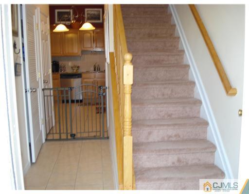 9 Lafayette Street Carteret, NJ 07008 - Photo 15 of 18 a view of a hallway with wooden floor and staircase