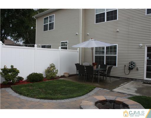 9 Lafayette Street Carteret, NJ 07008 - Photo 17 of 18 a backyard of a house with table and chairs