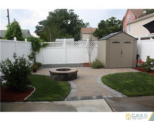 9 Lafayette Street Carteret, NJ 07008 - Photo 18 of 18 a view of a white house with a yard plants and large tree