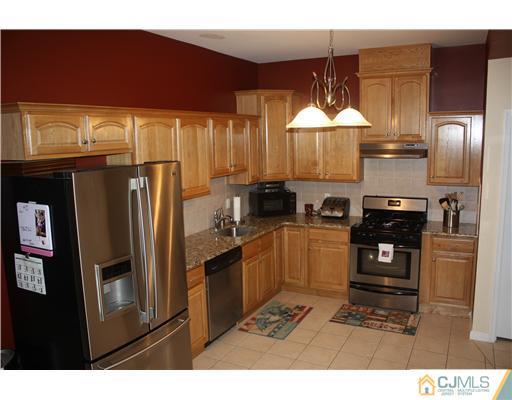 9 Lafayette Street Carteret, NJ 07008 - Photo 3 of 18 a kitchen with refrigerator cabinets and a sink