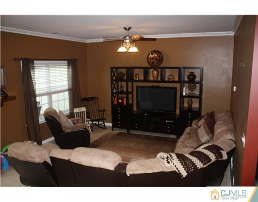 9 Lafayette Street Carteret, NJ 07008 - Photo 4 of 18 a living room with furniture and a flat screen tv