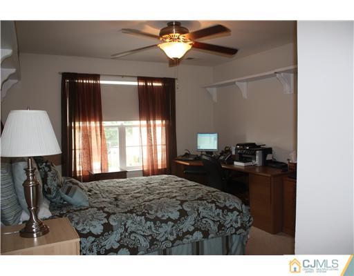 9 Lafayette Street Carteret, NJ 07008 - Photo 8 of 18 a bedroom with a bed and a chandelier