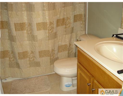 9 Lafayette Street Carteret, NJ 07008 - Photo 10 of 18 a bathroom with a sink toilet and shower