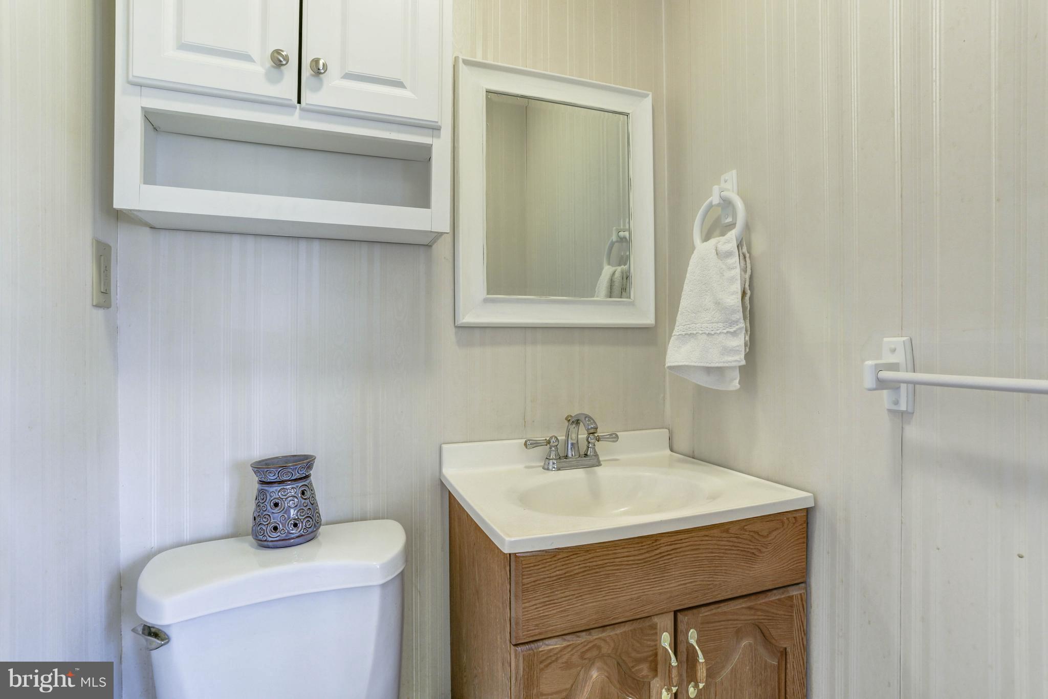 8266 WB&A Road Severn, MD 21144 - Photo 14 of 30 a bathroom with a sink a toilet and mirror
