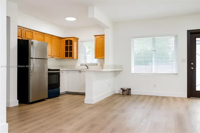 a kitchen with a refrigerator and window