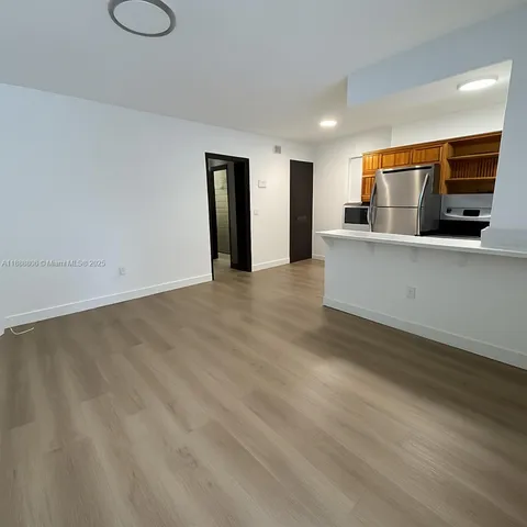 a view of kitchen with furniture and wooden floor