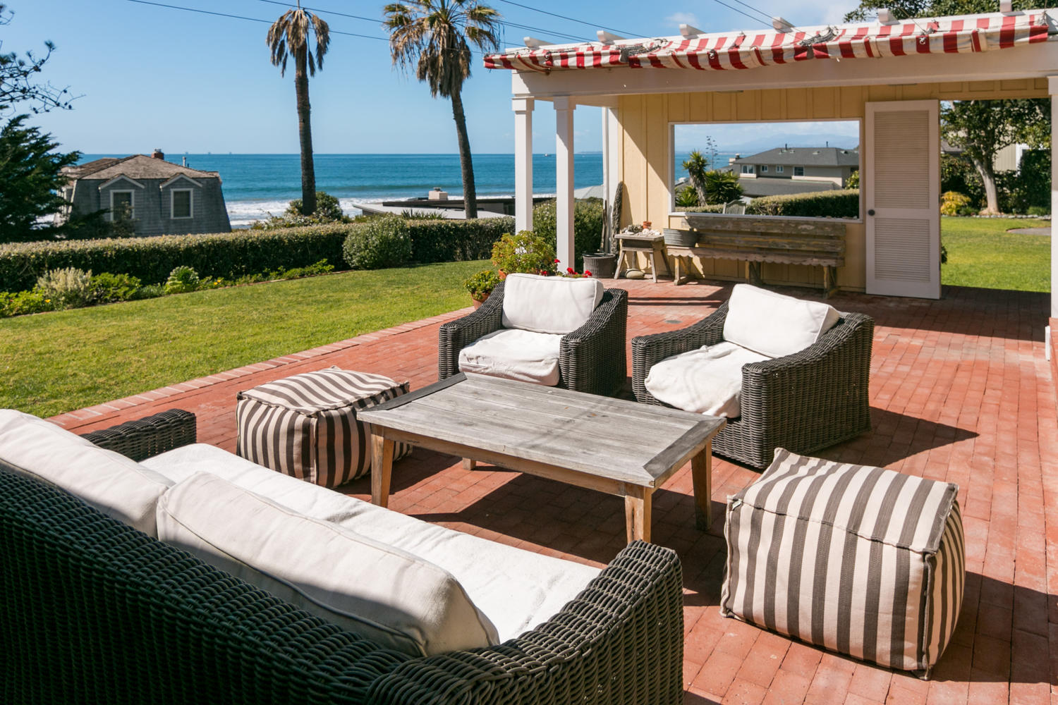 181 Rincon Point Road Carpinteria, CA 93013 - Photo 2 of 44 a view of a patio with couches chairs and a yard