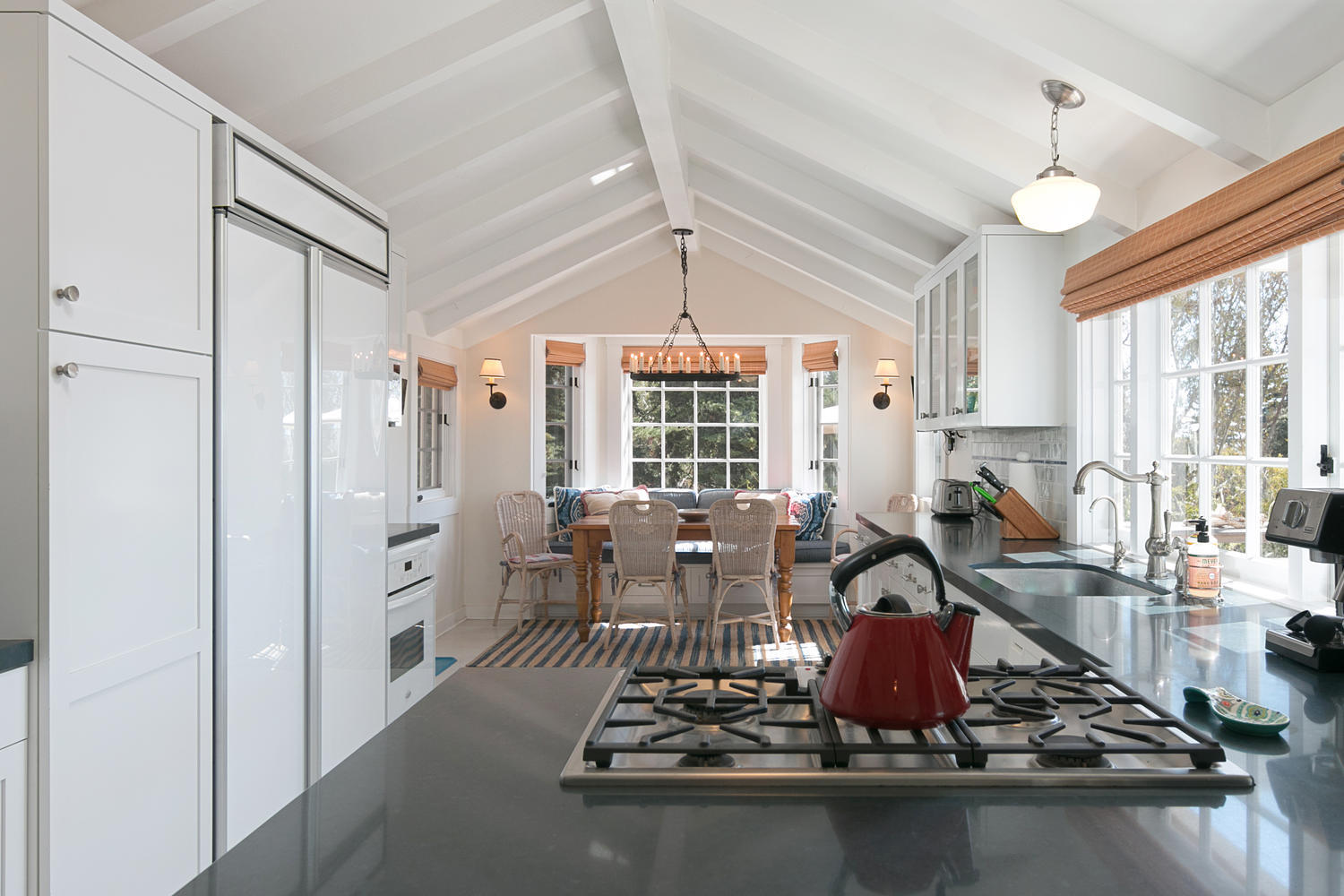 181 Rincon Point Road Carpinteria, CA 93013 - Photo 22 of 44 a room with lots of wooden furniture and large windows