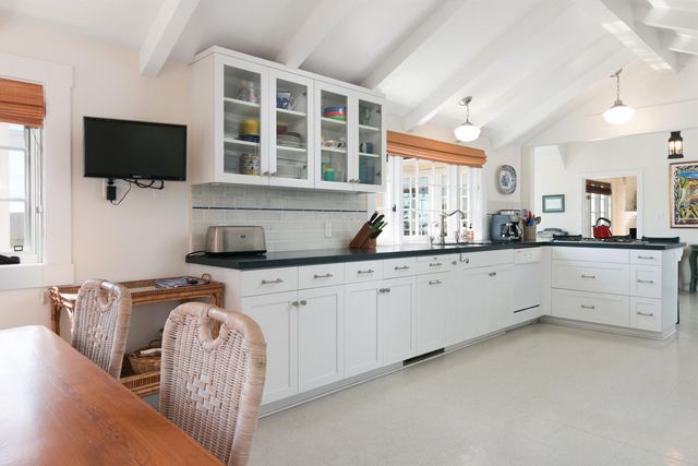 a kitchen with stainless steel appliances granite countertop a sink and a microwave