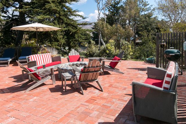 a view of an outdoor sitting area with furniture and umbrella