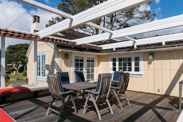 a view of a dining table and chairs in porch