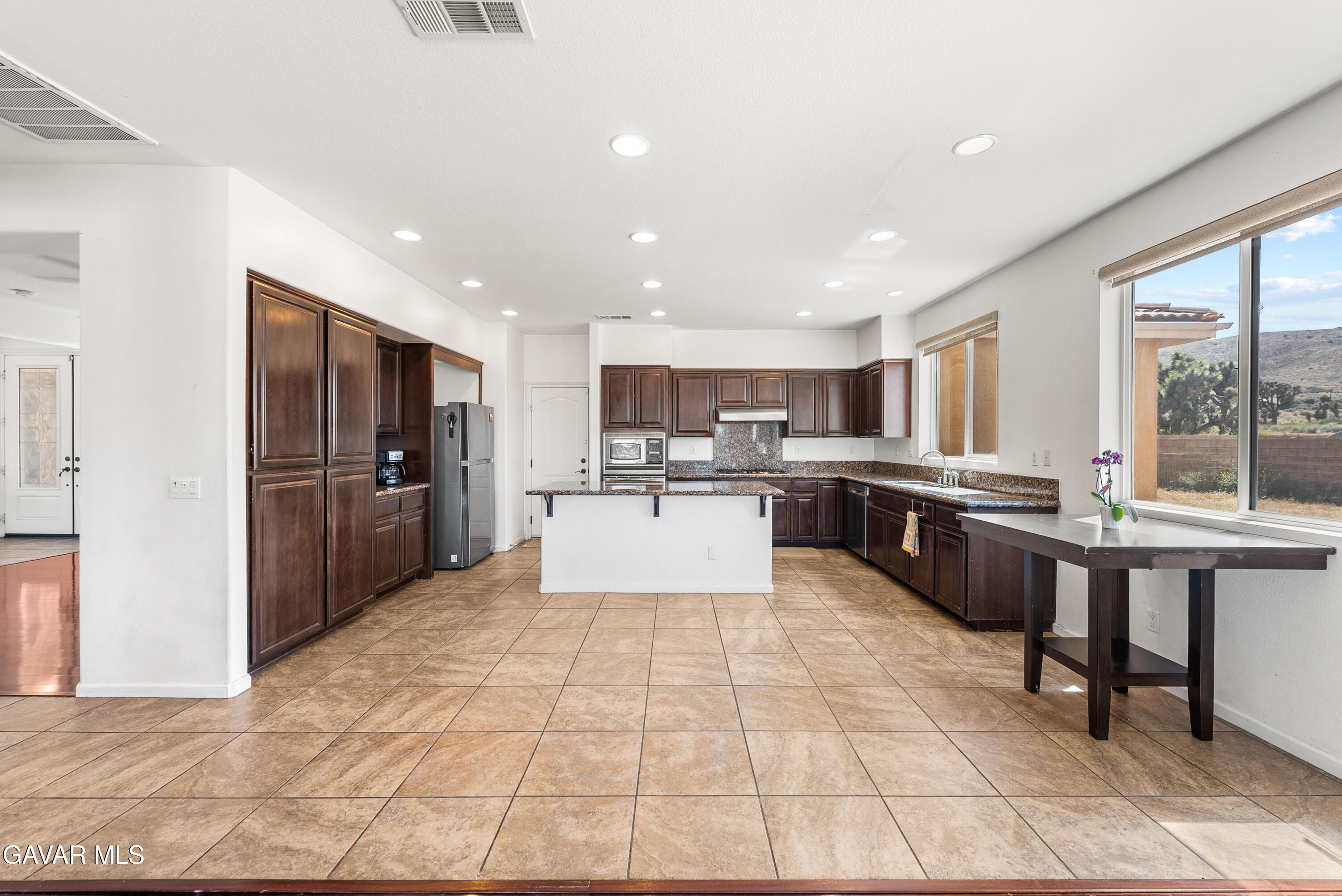 658 Lago Lindo Road Palmdale, CA 93550 - Photo 27 of 91 a large kitchen with a large counter top and stainless steel appliances