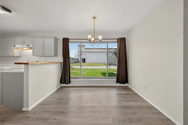 a view of an empty room with a fireplace and a window