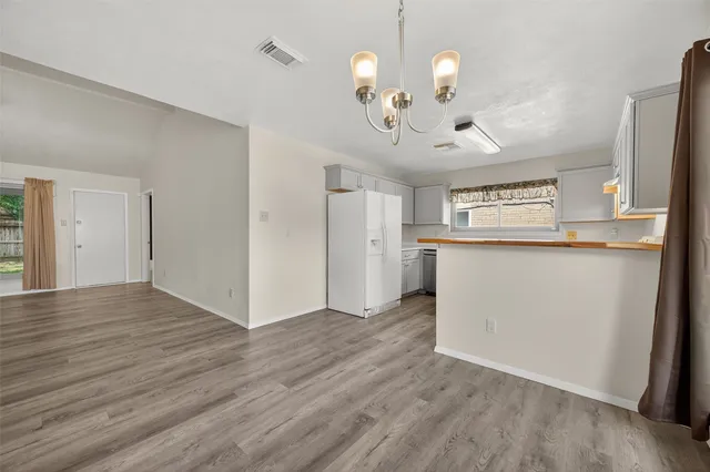 a view of a kitchen with a sink and wooden floor