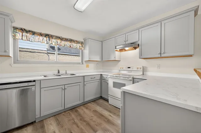 a kitchen with a sink cabinets and window