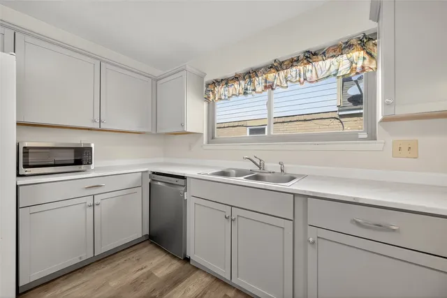 a kitchen with appliances cabinets and a sink
