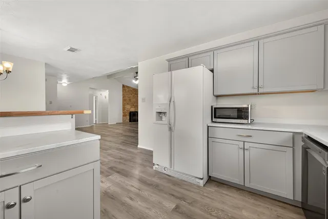 a kitchen with stainless steel appliances a refrigerator sink and cabinets
