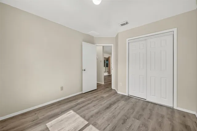 a view of an empty room and wooden floor
