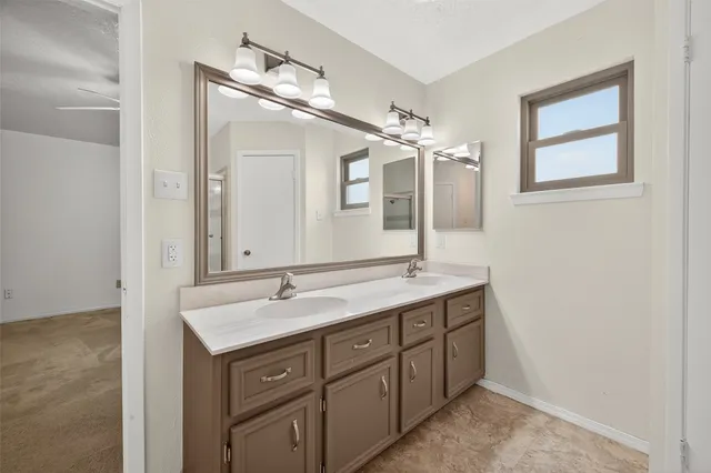 a bathroom with a granite countertop sink mirror and double