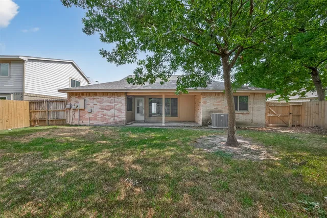 a view of a house with a yard and a garden