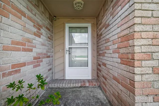 a view of a brick house with a potted plant