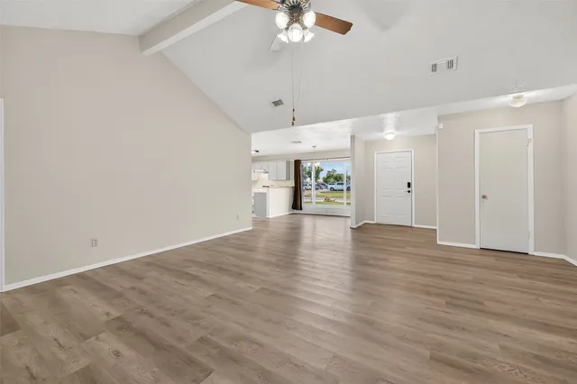 wooden floor in an empty room with a window