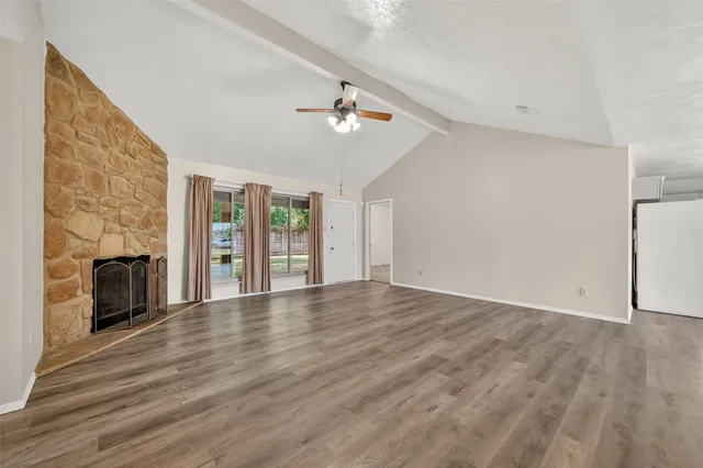 wooden floor in an empty room with a fireplace