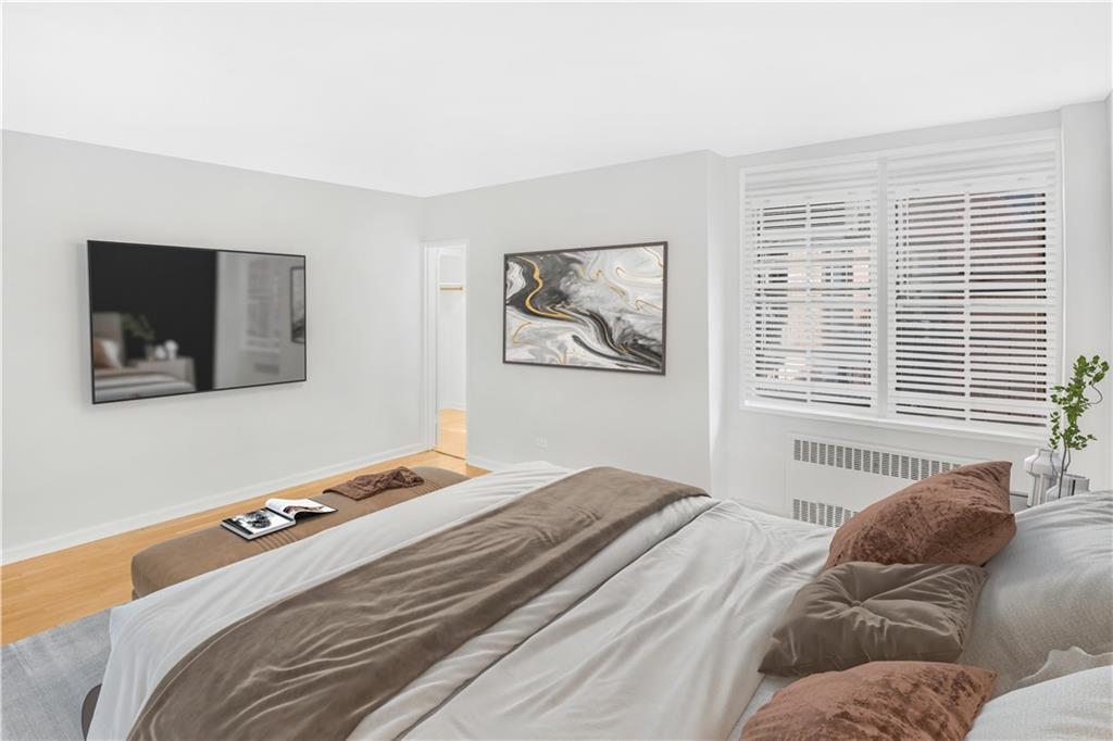 7259 Shore Road, Unit 3A Brooklyn, NY 11209 - Photo 2 of 11 a bedroom with a bed and a couch