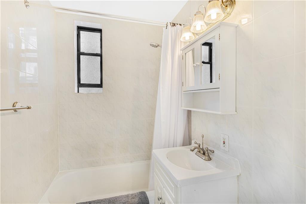 7259 Shore Road, Unit 3A Brooklyn, NY 11209 - Photo 8 of 11 a white bath tub sitting next to a white sink