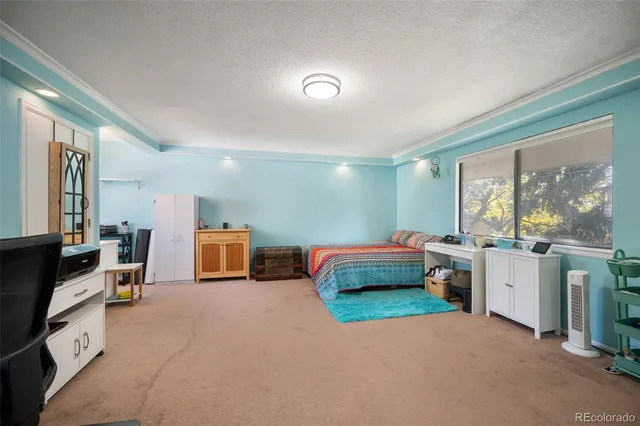 a bedroom with furniture and a window