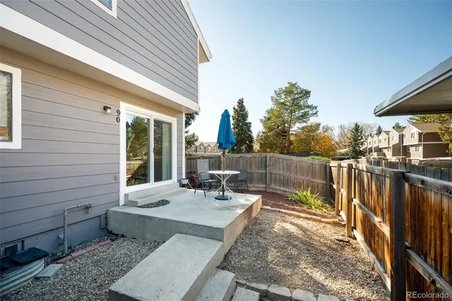 a view of a chair and tables in the balcony