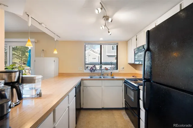 a kitchen with a sink appliances and cabinets