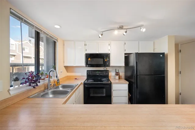 a kitchen with a refrigerator and a stove