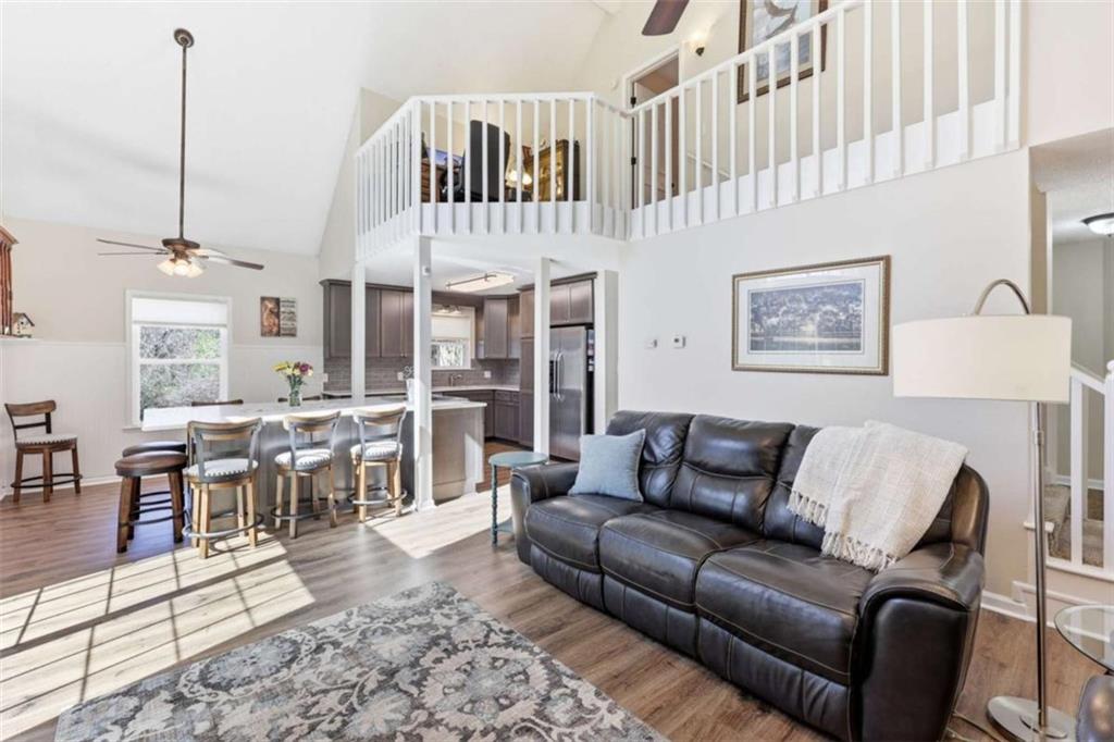4033 Mt Vernon Road Gainesville, GA 30506 - Photo 11 of 47 a living room with furniture wooden floor and a view of kitchen