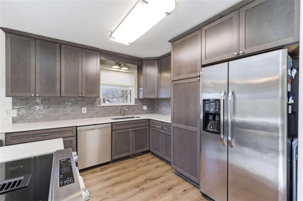 4033 Mt Vernon Road Gainesville, GA 30506 - Photo 14 of 47 a kitchen with stainless steel appliances granite countertop a refrigerator and a sink