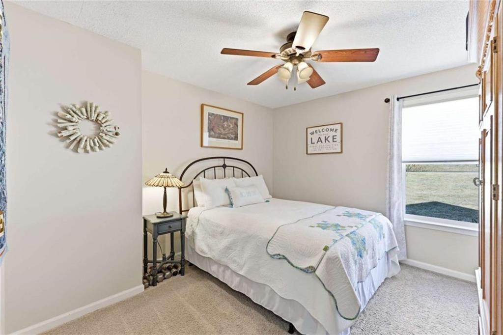 4033 Mt Vernon Road Gainesville, GA 30506 - Photo 17 of 47 a bedroom with a bed and a chandelier