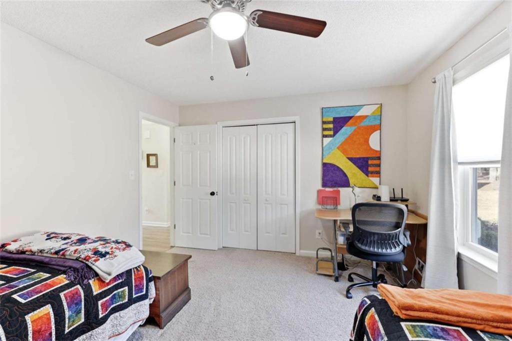 4033 Mt Vernon Road Gainesville, GA 30506 - Photo 21 of 47 a bedroom with a bed and a chandelier